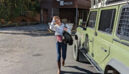 Woman approaching Landrover Defender in front of backdoor of Montauk Manor