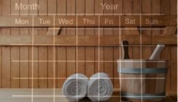 wall section of a sauna, with a water bucked and towels displayed, all of which has a calendar overlayed - visually representing long term sauna effects